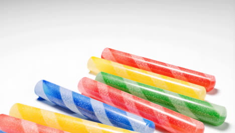 colorful striped candy sticks on white background