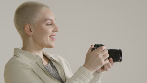vista lateral de una mujer joven con una cámara dslr