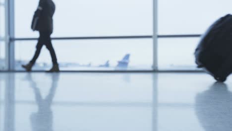 walking people feet and shoes in airport. business people and travellers walk with luggage and baggage going on air travel in departure transit hall. real time red cinema.