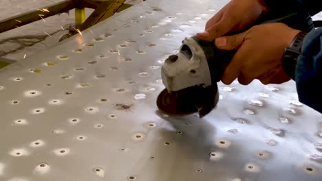 person working with angle grinder and making sparks, close up