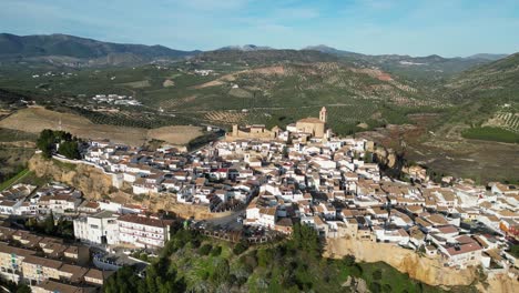 iznajar white mountain village and castle in andalusia, spain - aerial 4k circling