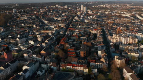 Aerial-drone-view-of-urban-neighbourhood.-Buildings-illuminated-by-bright-sun-in-golden-hour.-Frankfurt-am-Main,-Germany