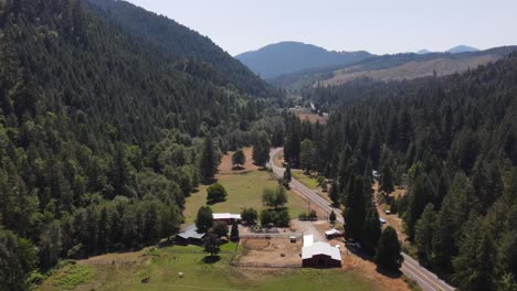 Aerial-movement-forward-of-Roseburg,-Oregon-during-the-summer-over-farms