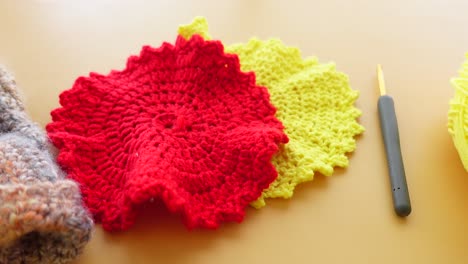 crocheting red and yellow coasters