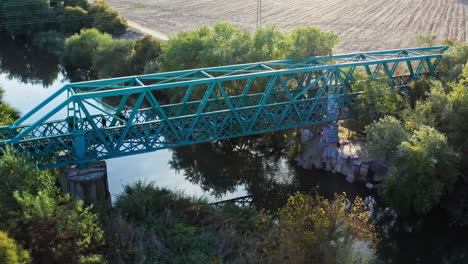 Group-of-people-on-an-abandoned-lost-railway-bridge-in-the-sunset-in-Spain