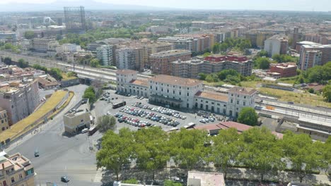 aerial orbiting shot above rome's trastevere train station in italy on beautiful summer afternoon