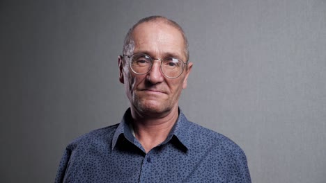 elderly man with bad eyesight wears elegant glasses smiling