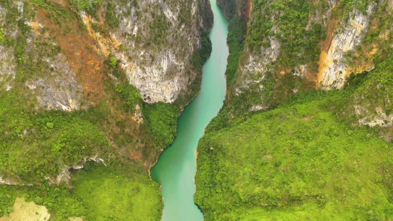 incline lentamente hacia arriba para revelar el hermoso agua verde azul turquesa que atraviesa montañas empinadas en el norte de vietnam