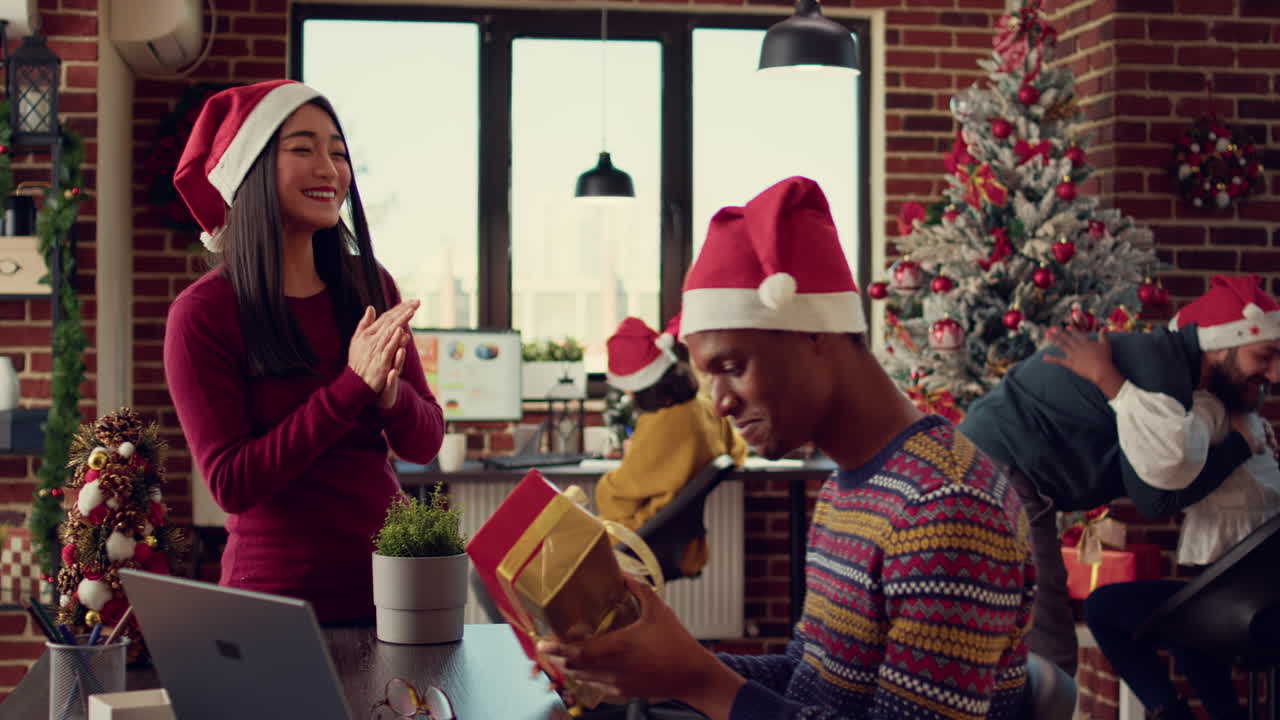 Diverse people exchanging gifts at office job