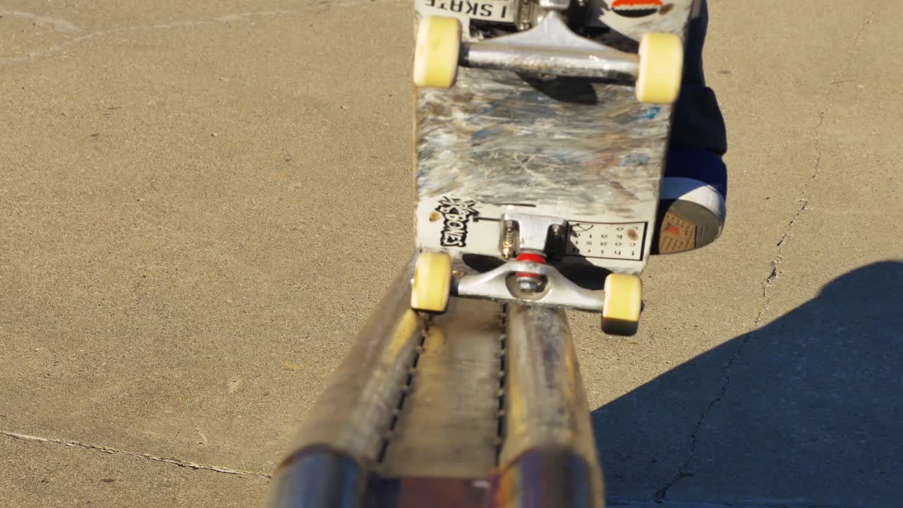 Skater does a trick on ledge at the skate park