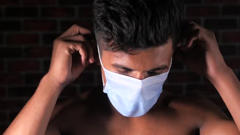 man putting on a face mask