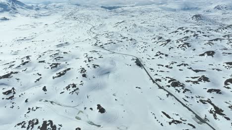 highest point of sognefjellet mountain pass - road 1428 meters above sea level - spring aerial with melting snow left in landscape
