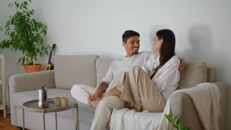 playful family flirting couch closeup. handsome man cuddling woman relaxing sofa