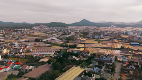 aerial view of greenhouses and houses in the mountains of vietnam