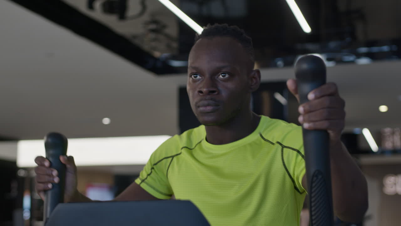 Man Exercising on a Treadmill in a Gym