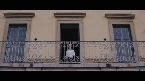 man standing on a balcony