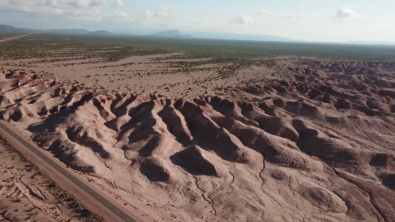 Aerial View of Desert Landscape in Outback of Argentina With Freeway Road and Red Sandstone Hills