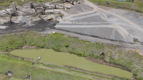 mining site with trucks and stone piles