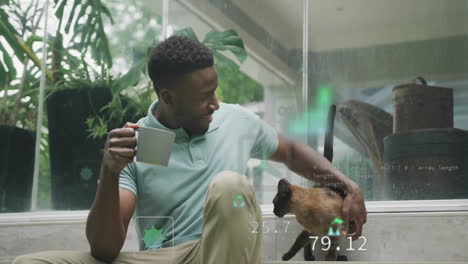 animation of icon, computer language, african american man playing with dog while drinking coffee
