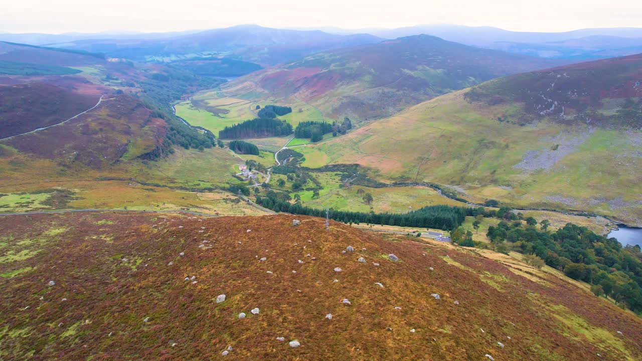 A rising 4K drone shot of the lower Lough Tay Valley