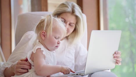 mother and toddler learning on laptop