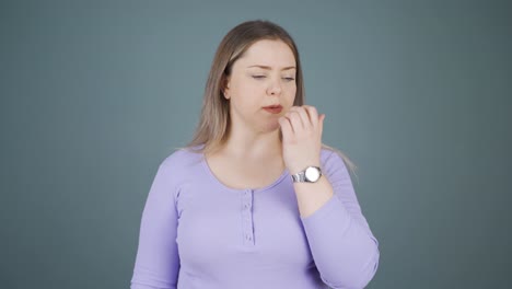 The-young-woman-is-biting-her-nails.