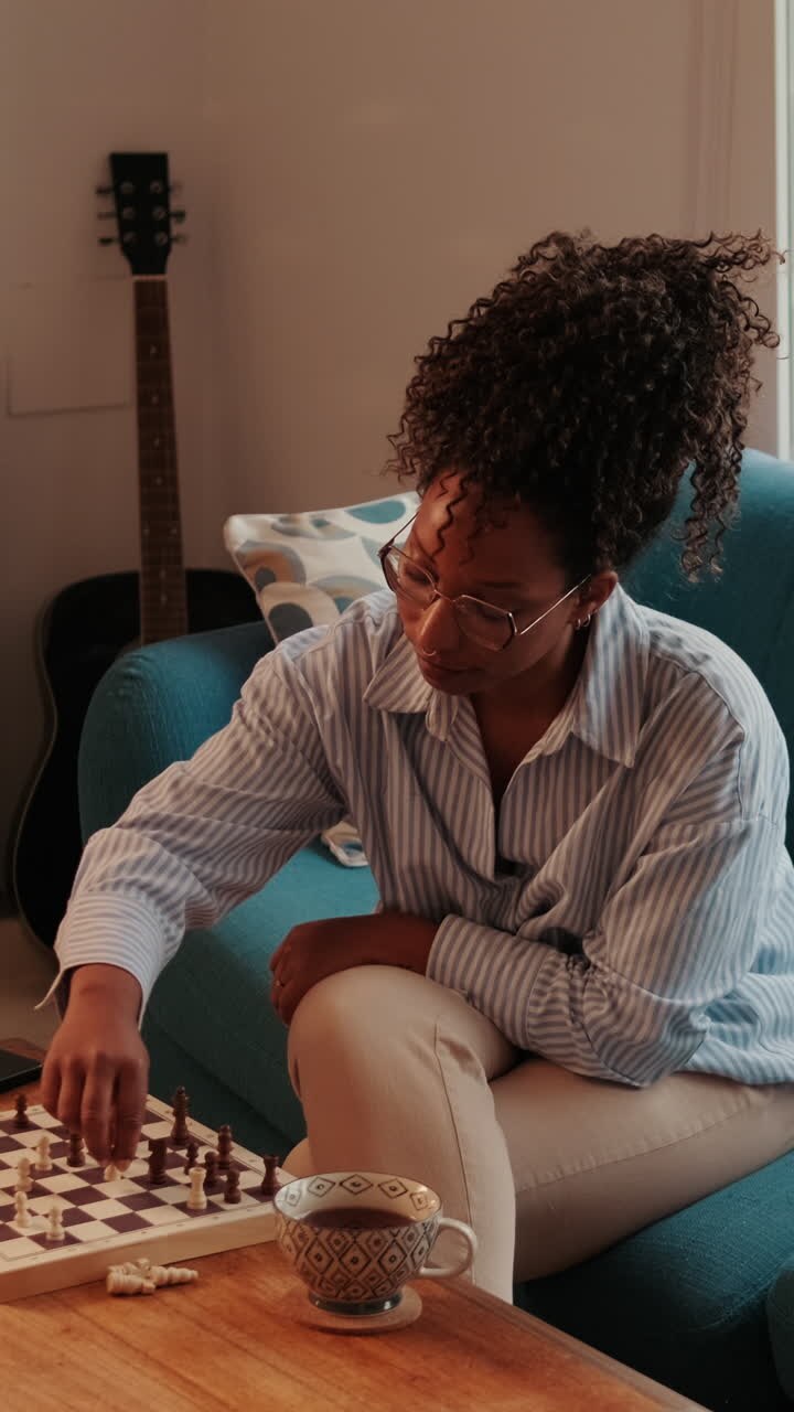 Woman Playing Chess at Home on Sofa