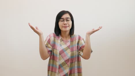 pretty asian woman pointing fingers left and right, making decision, showing two variants choices