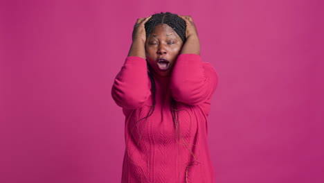 a woman covering her face with her hands