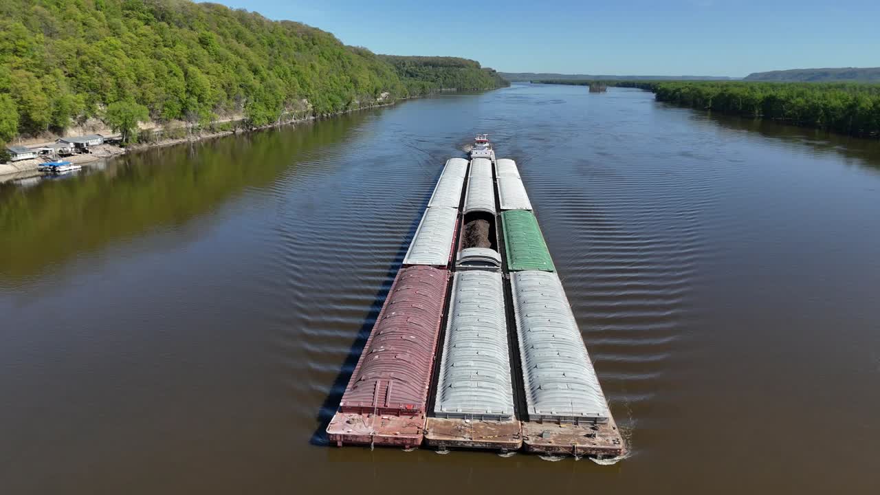 Located along the Mississippi River between Minnesota and Wisconsin's Driftless area, a towboat move a set of barges south.