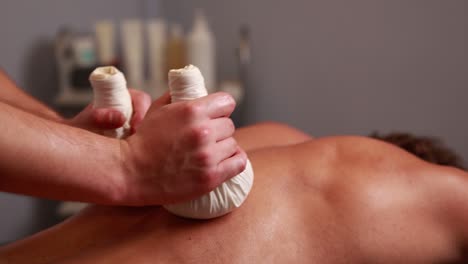 back massage with herbal compress