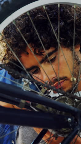 mechanic repairing bicycle in workshop