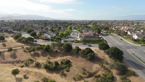 aerial of dry open landscape within park boundary and nearby suburban edge of salinas