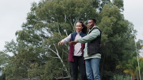 Camping,-happy-couple-and-pointing-to-forest