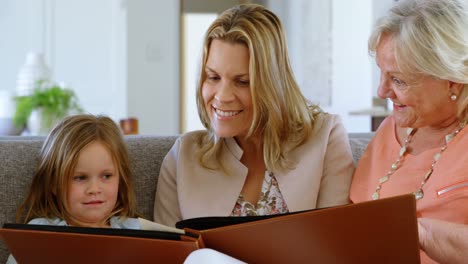family looking photo album in living room 4k