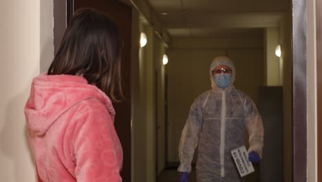 medical worker doctor in suit visiting woman at home offering vaccine against coronavirus covid-19