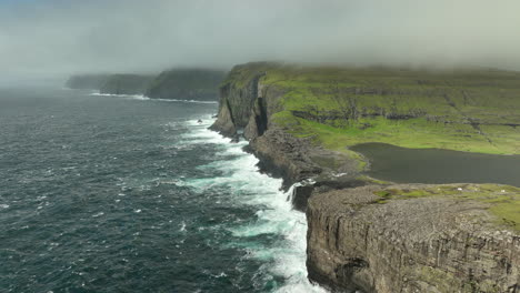 rugged coastline of faroe islands - sorvagsvatn waterfall aerial