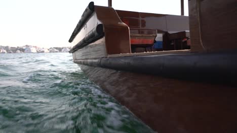 Close-up-view-of-a-boat-in-traversing-in-Dubai-Creek-In-United-Arab-Emirate