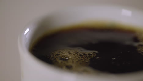 close up of coffee being filled into a mug