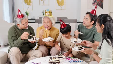 a family enjoys a birthday celebration, sharing cake and laughter in a cozy living room setting