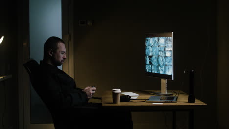 man with smartphone in the hut at night