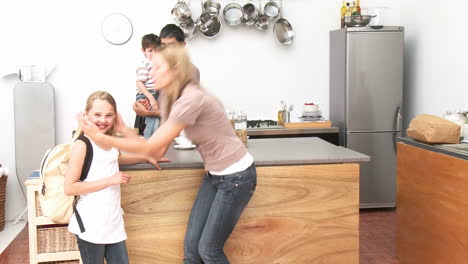 Mother-giving-her-daughter-a-kiss-before-going-to-school