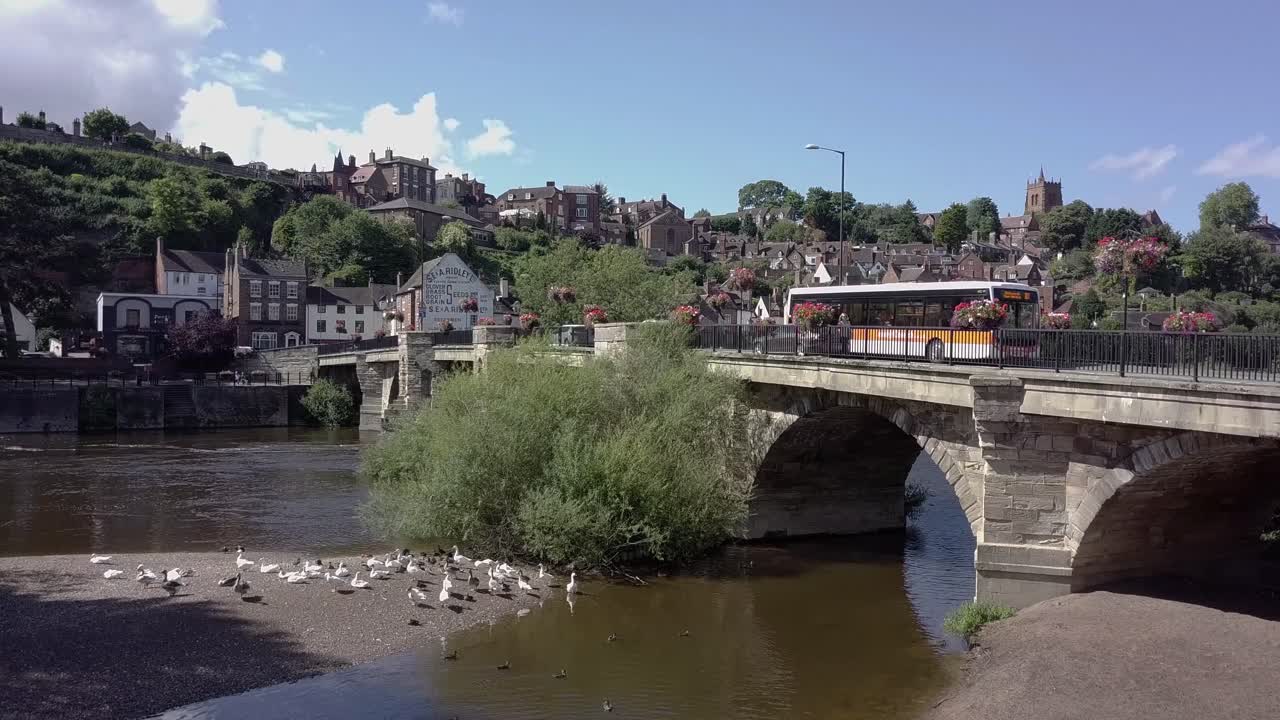 Drone slowly rises up from the bank of the River Severn at Bridnorth next to the bridge and rising to reveal High Town, Shropshire, UK - 30 Second Version