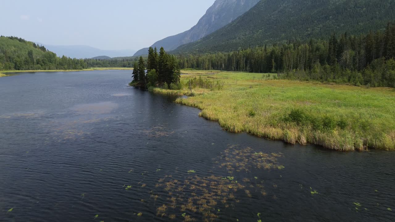 Low Dolly Drone Shot Over the Wetlands of Seeley Lake Provincial Park in Smithers, Canada