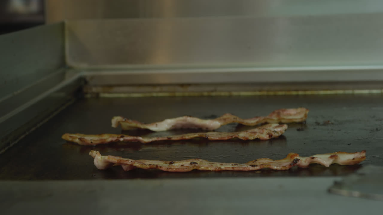 Bacon cooking on a hot plate