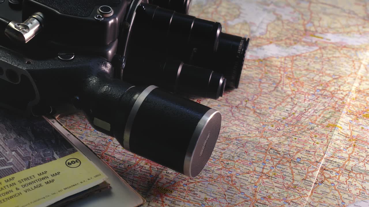 Vintage 8mm camera with travel road maps evoke nostalgic journeys