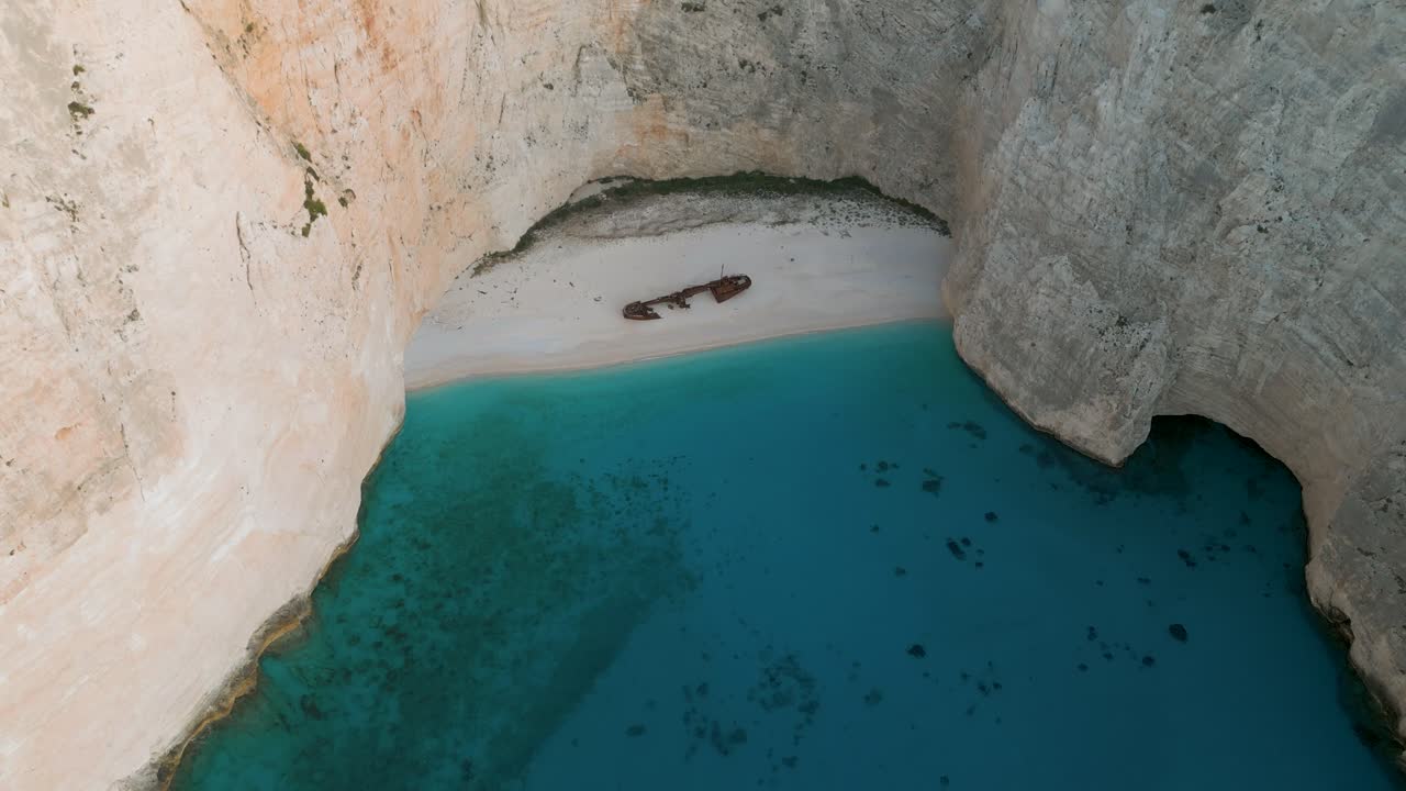 Secluded beach with a shipwreck in Zante, Greece, surrounded by cliffs and turquoise water