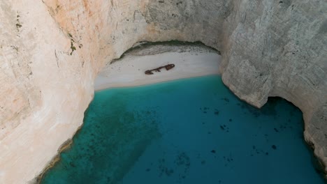 secluded beach with a shipwreck in zante, greece, surrounded by cliffs and turquoise water