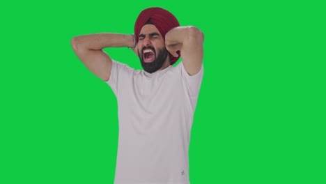 angry sikh indian man challenging someone for fight green screen