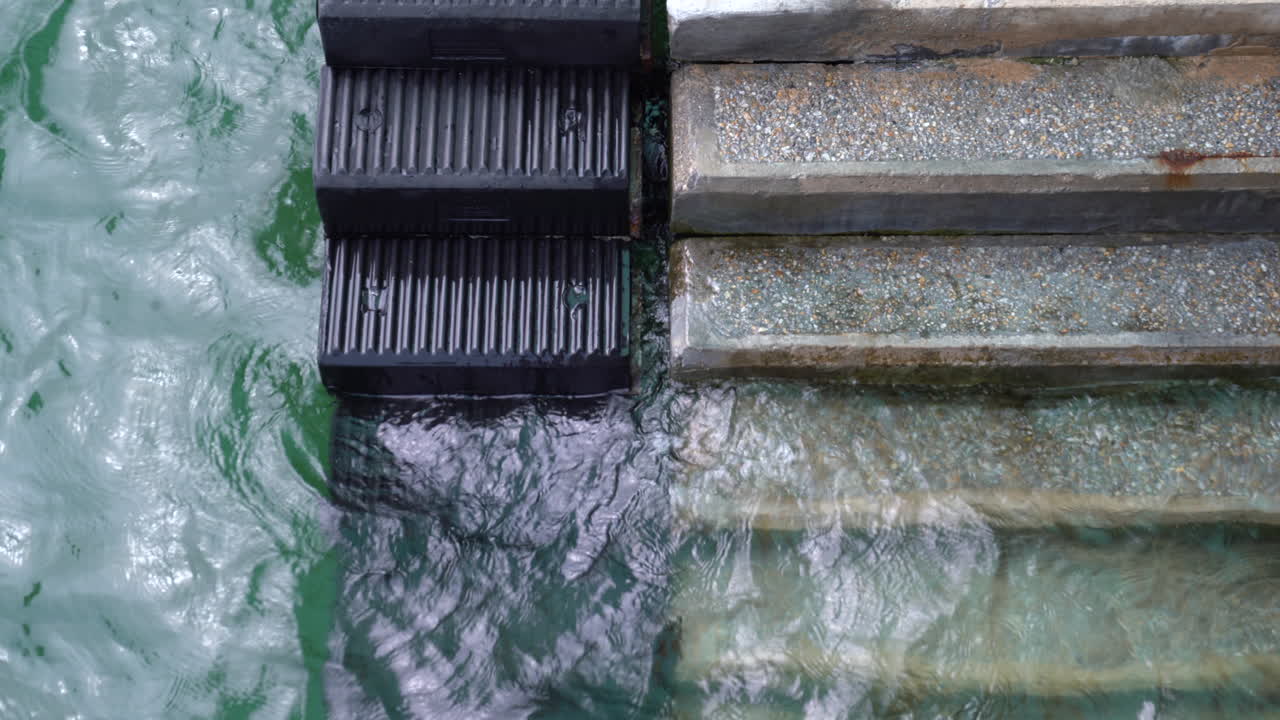 Cold waves crashing on a staircase in a lake on a gloomy winters day